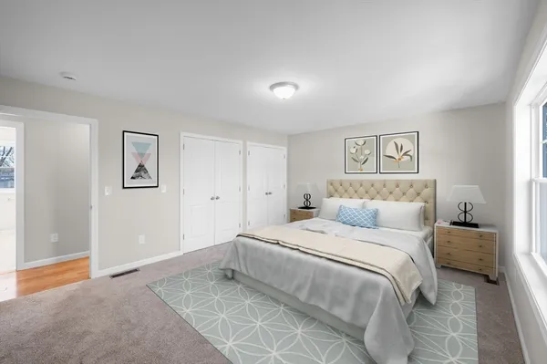 a bedroom with a bed and a painting on the wall