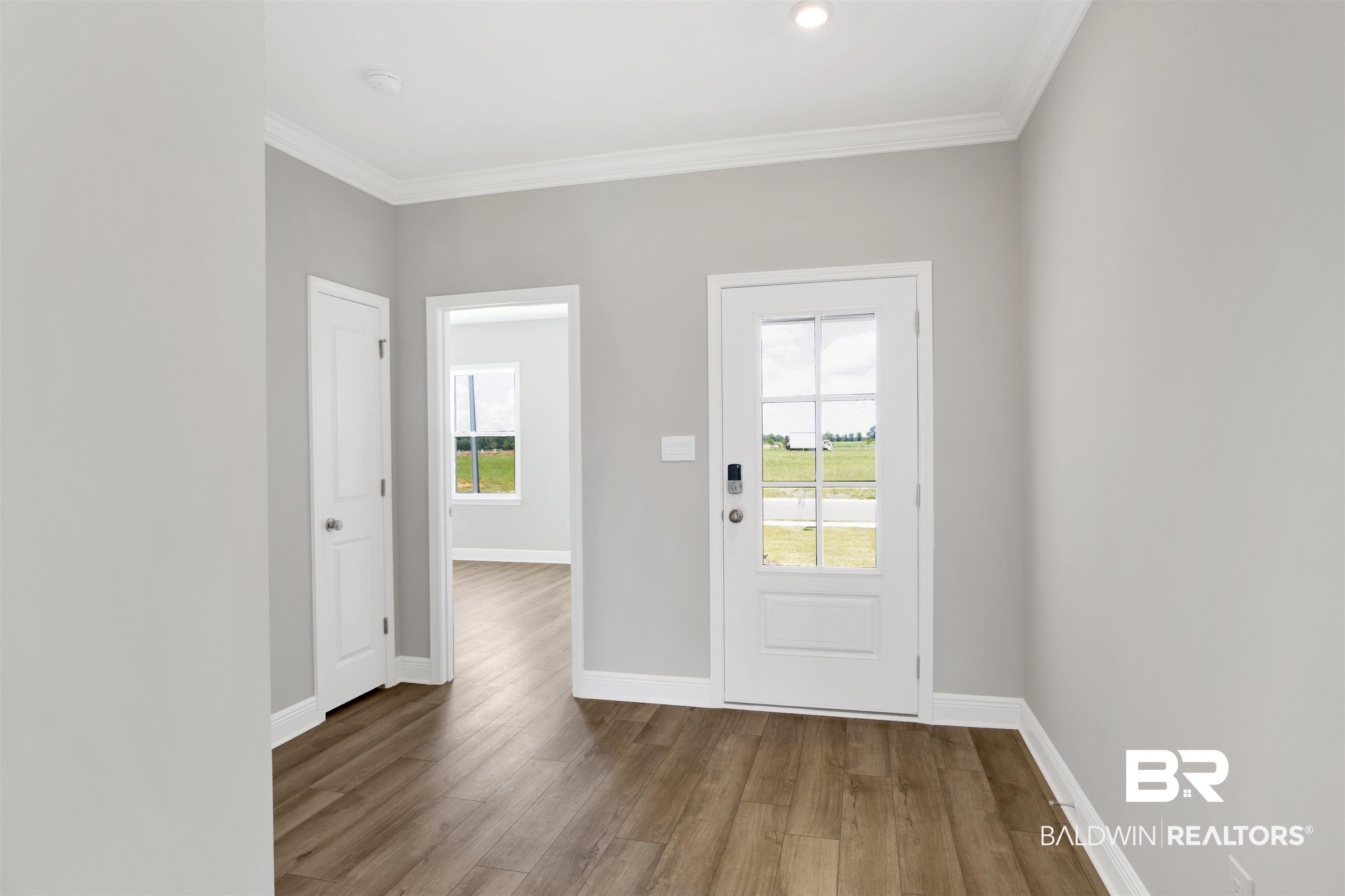 23852 Lafite Circle Daphne, AL 36526 - Photo 3 of 30 Entryway with wood finished floors and ornamental molding