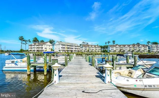 a view of a ocean with boats and trees in the background