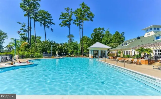 a view of a house with a yard and potted plants