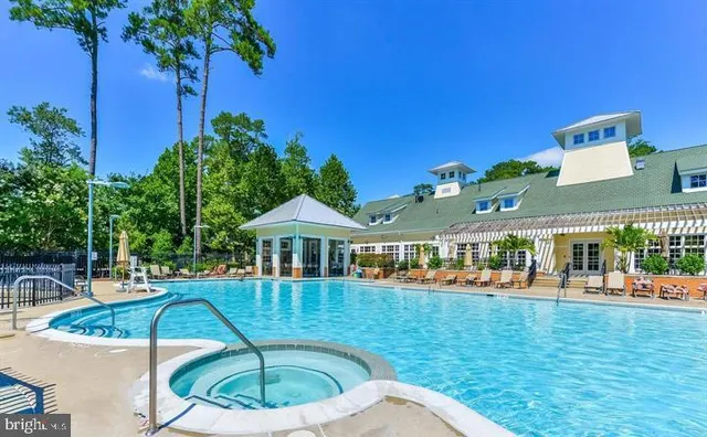 a swimming pool with outdoor seating and yard