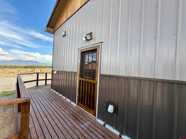 a view of a balcony with furniture and wooden floor