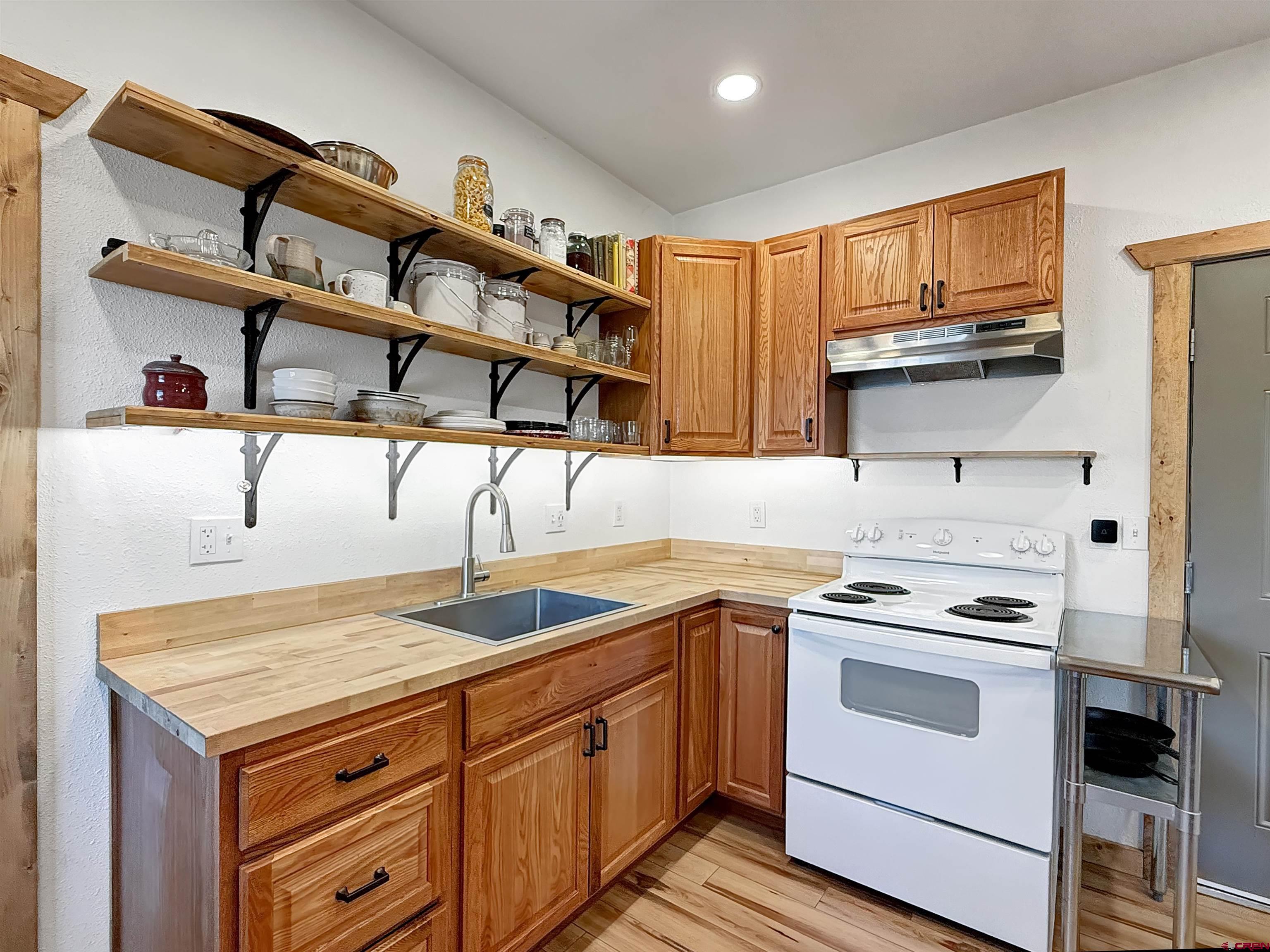 75707 B76 Road Crawford, CO 81415 - Photo 26 of 44 a kitchen with stainless steel appliances granite countertop a stove and a sink