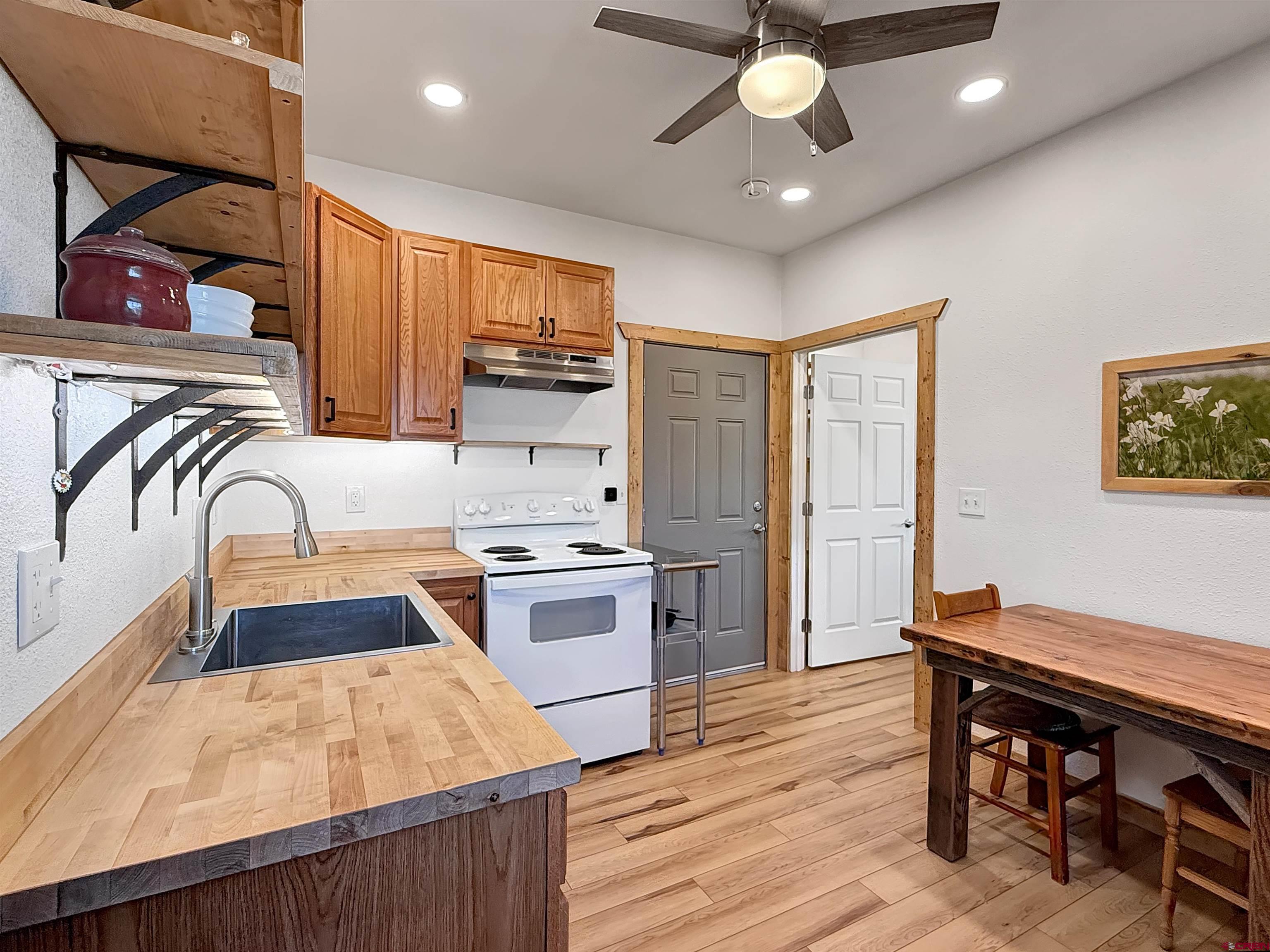 75707 B76 Road Crawford, CO 81415 - Photo 27 of 44 a kitchen with stainless steel appliances granite countertop a sink stove and refrigerator