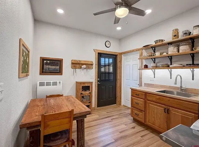 a kitchen with a table chairs stove and refrigerator