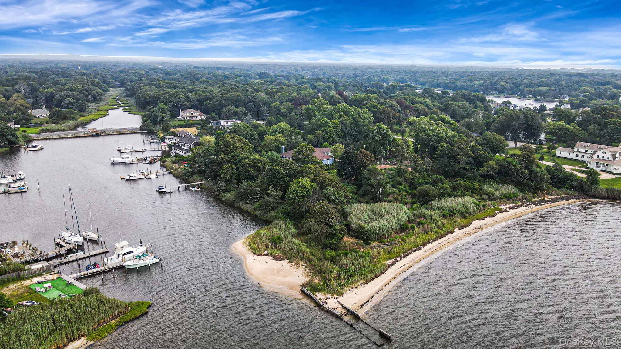 Private Private Road Center Moriches, NY 11934 - Photo 1 of 1 Birds eye view of property featuring a water view and a wooded view