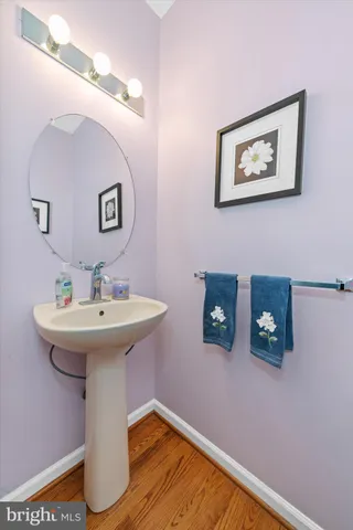 a bathroom with a sink mirror and toilet