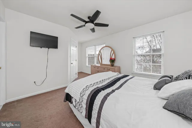 a bedroom with a bed window and flat screen tv