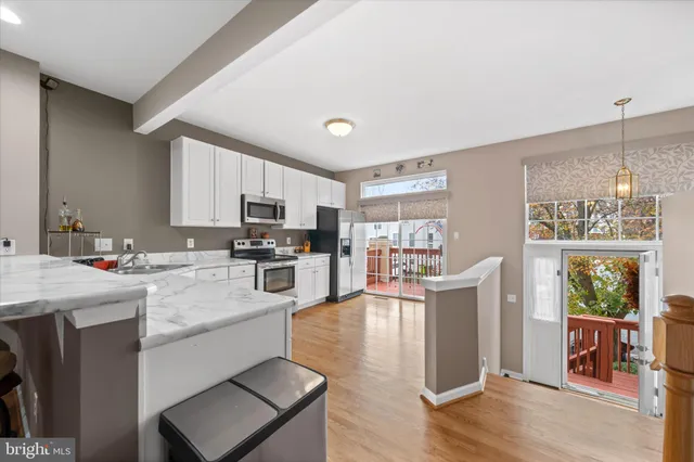 a kitchen with cabinets and wooden floor