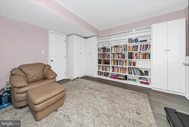 a living room with furniture and a book shelf