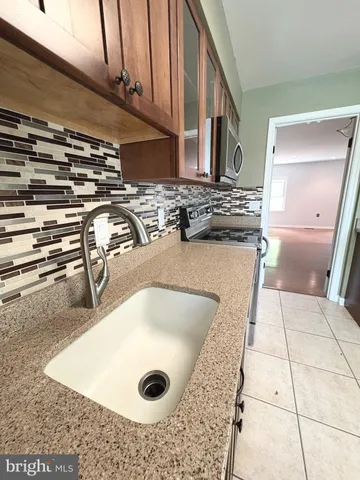a kitchen with a refrigerator and a sink