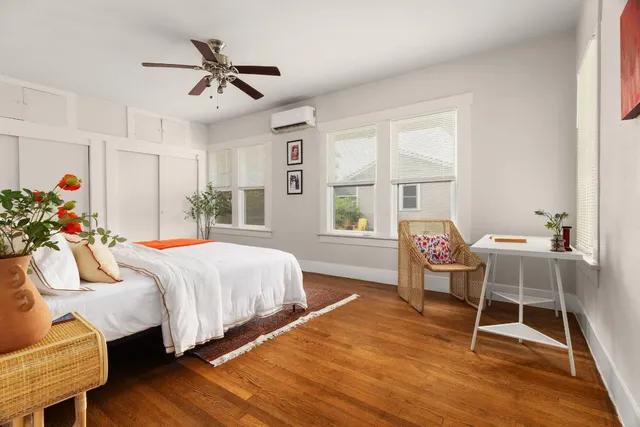 a bed room with a bed and a chair