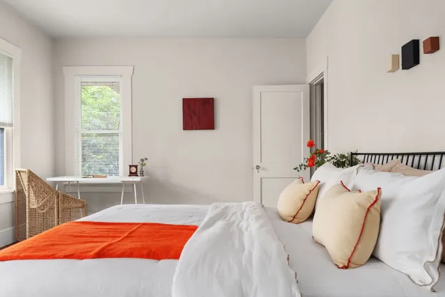 a bedroom with a bed and a window