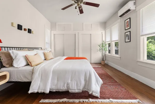 a bed sitting in a bedroom next to a window