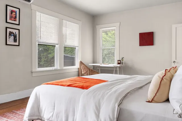 a bedroom with a bed and a window