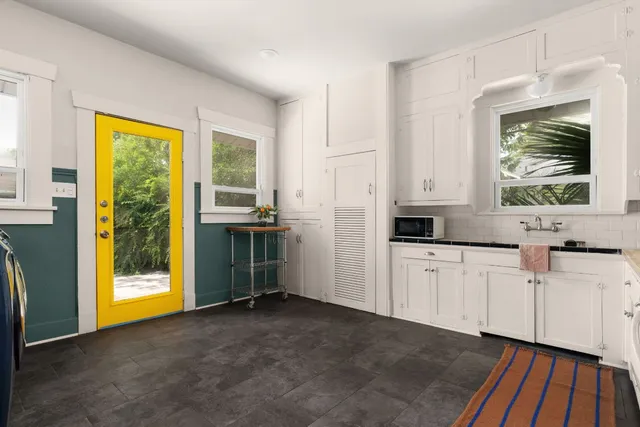 a kitchen with stainless steel appliances a refrigerator sink and cabinets