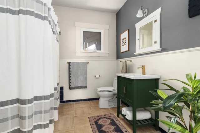 a bathroom with a sink toilet and mirror