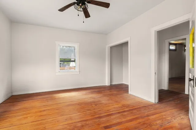 a view of an empty room with wooden floor
