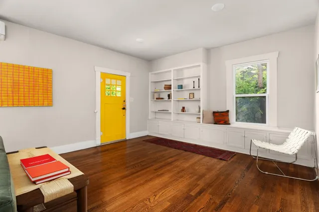 a view of a room with wooden floor and windows