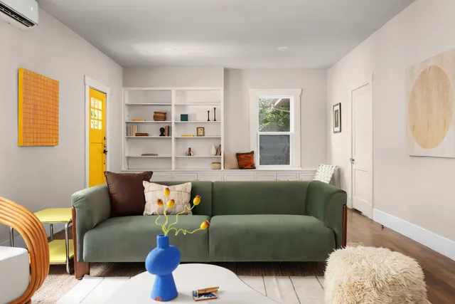 a living room with furniture and a potted plant