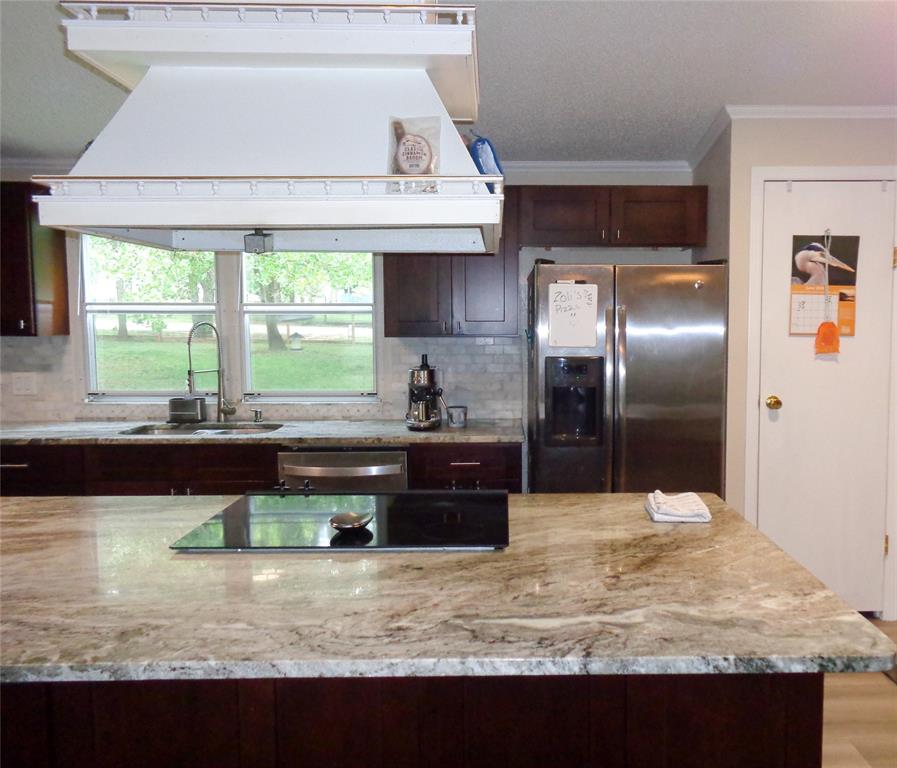 5525 Cedar Oaks Road Grandview, TX 76050 - Photo 6 of 40 Kitchen featuring new real wood soft close cabinetry, granite countertops, a stainless-steel sink with a gooseneck faucet, a tile backsplash, wood-finish flooring, and custom designed/fabricated Island