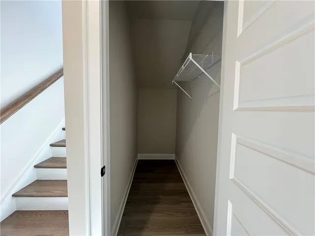 a view of a hallway with wooden floor and entryway