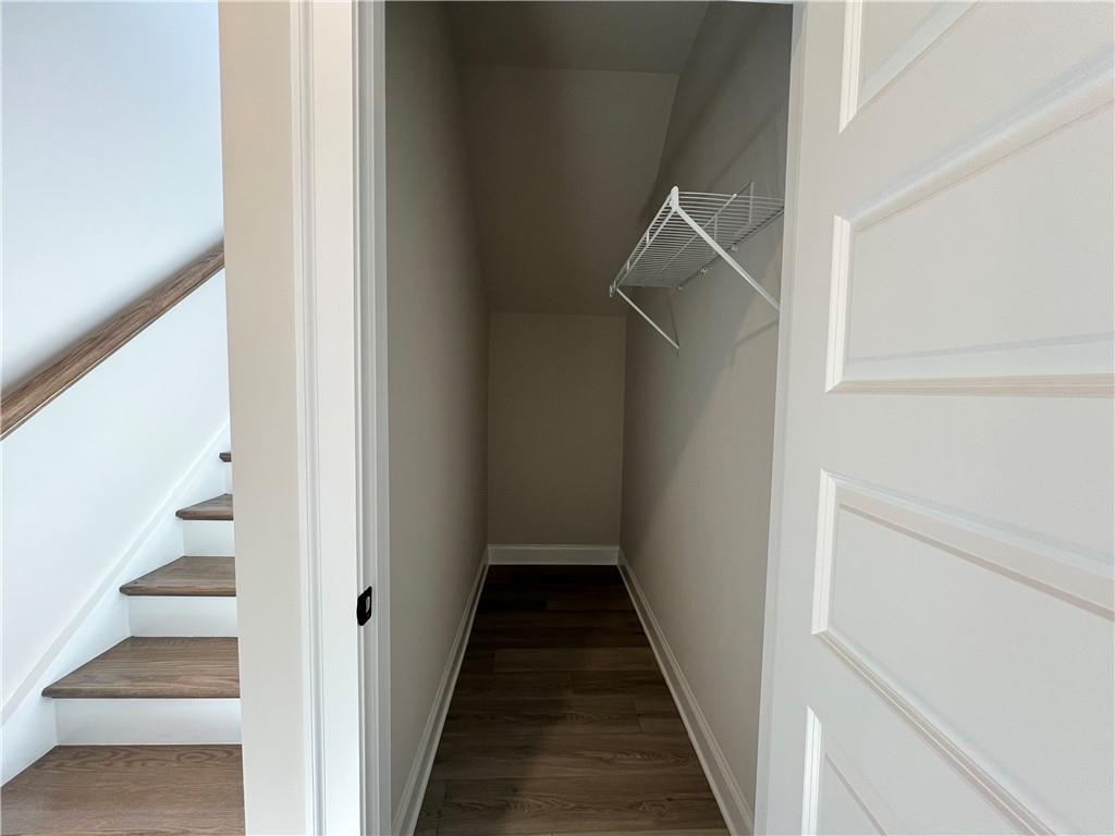 2969 Sweet Red Circle Braselton, GA 30517 - Photo 12 of 49 a view of a hallway with wooden floor and entryway