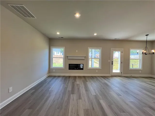 a living room with a fireplace and windows