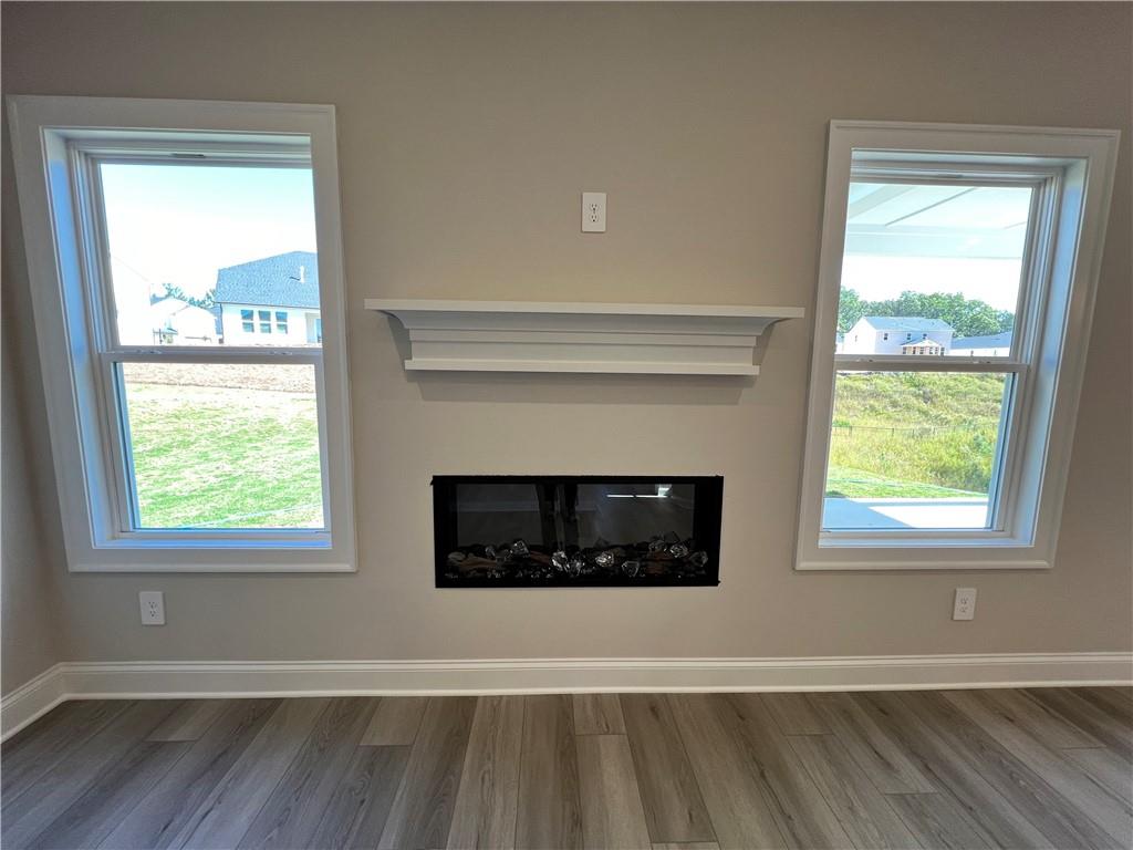 2969 Sweet Red Circle Braselton, GA 30517 - Photo 19 of 49 a living room with a fireplace and windows