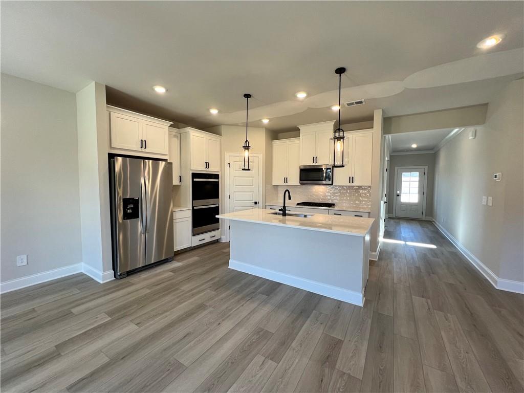 2969 Sweet Red Circle Braselton, GA 30517 - Photo 20 of 49 a large kitchen with stainless steel appliances kitchen island a large counter top and a refrigerator