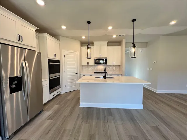 a kitchen with cabinets and stainless steel appliances