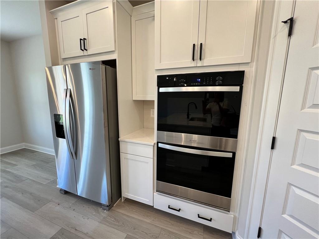 2969 Sweet Red Circle Braselton, GA 30517 - Photo 22 of 49 a kitchen with cabinets and stainless steel appliances