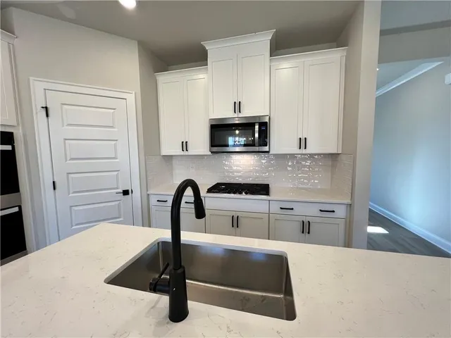a kitchen with a sink and chandelier