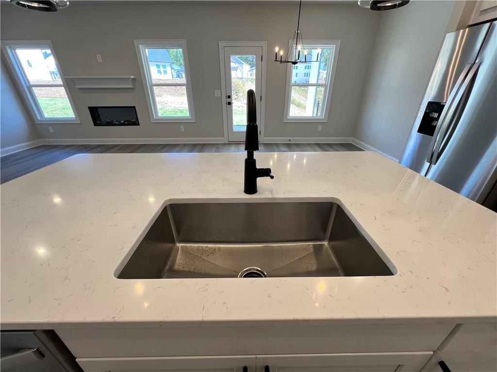 2969 Sweet Red Circle Braselton, GA 30517 - Photo 24 of 49 a kitchen with a sink and chandelier