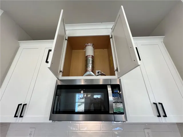 a white toilet sitting next to a bath tub