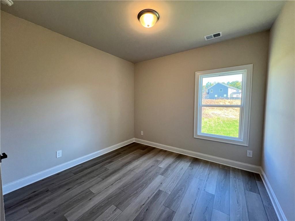 2969 Sweet Red Circle Braselton, GA 30517 - Photo 28 of 49 an empty room with wooden floor and windows