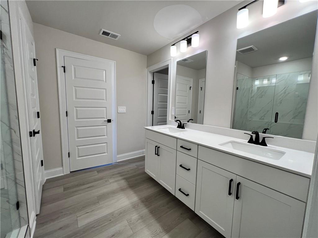 2969 Sweet Red Circle Braselton, GA 30517 - Photo 34 of 49 a spacious bathroom with double sink and a large mirror