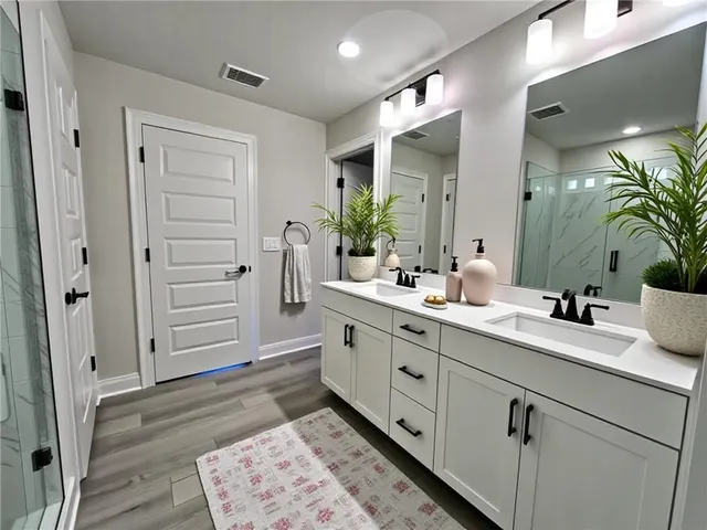 a spacious bathroom with a granite countertop sink and a mirror