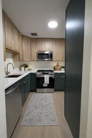 a kitchen with stainless steel appliances granite countertop a stove top oven a sink and dishwasher