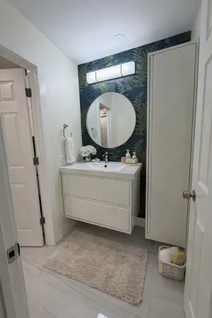 a bathroom with a sink mirror vanity and toilet