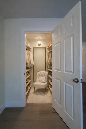 a bedroom with a bed and a mirror