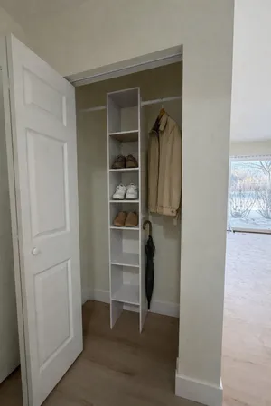 a view of walk in closet with empty racks