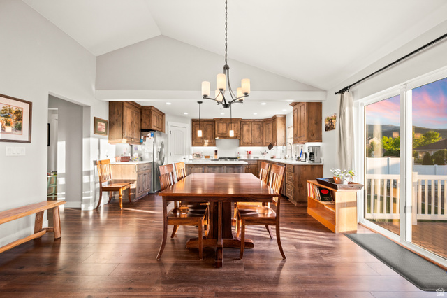 1145 North Christley Lane, Unit 48 Elk Ridge, UT 84651 - Photo 7 of 38 Open-concept living area featuring a vaulted ceiling and wood-finish flooring