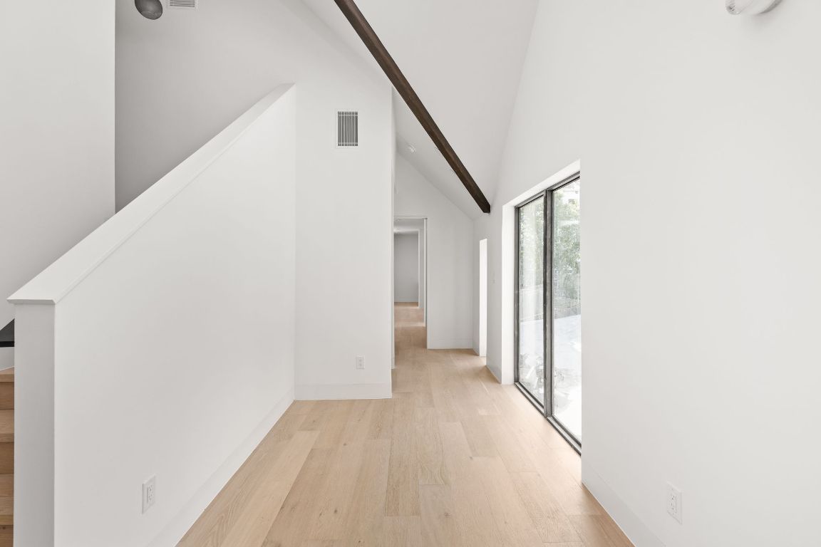 1603 Chelsea Lane, Unit 3 Austin, TX 78704 - Photo 13 of 40 Hallway featuring high vaulted ceiling and light wood-style flooring