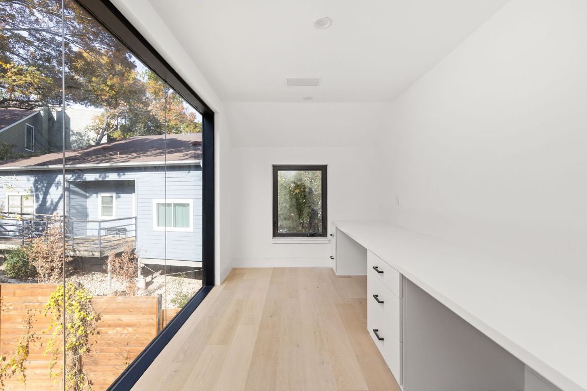 1603 Chelsea Lane, Unit 3 Austin, TX 78704 - Photo 16 of 40 Hallway featuring a desk and light wood-style floors
