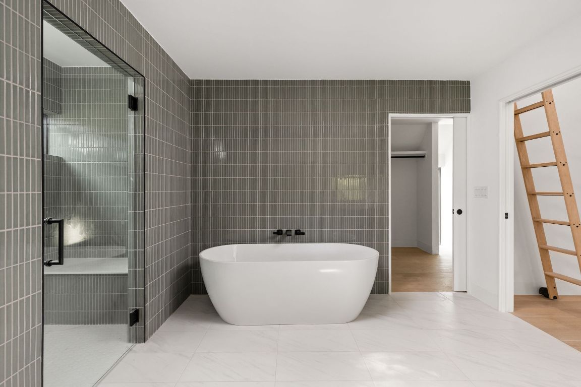 1603 Chelsea Lane, Unit 3 Austin, TX 78704 - Photo 20 of 40 Full bath featuring tile walls, a freestanding bath, and a shower stall