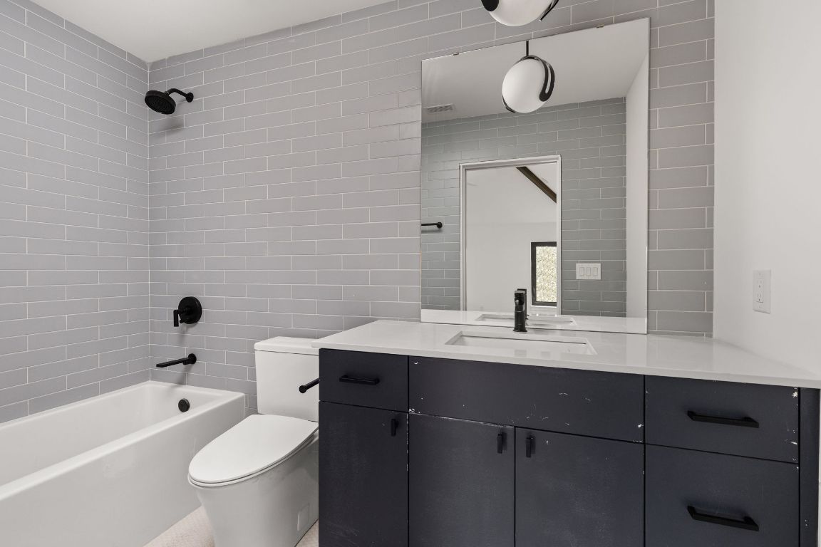 1603 Chelsea Lane, Unit 3 Austin, TX 78704 - Photo 26 of 40 Bathroom with vanity, shower / bath combination, and tile walls
