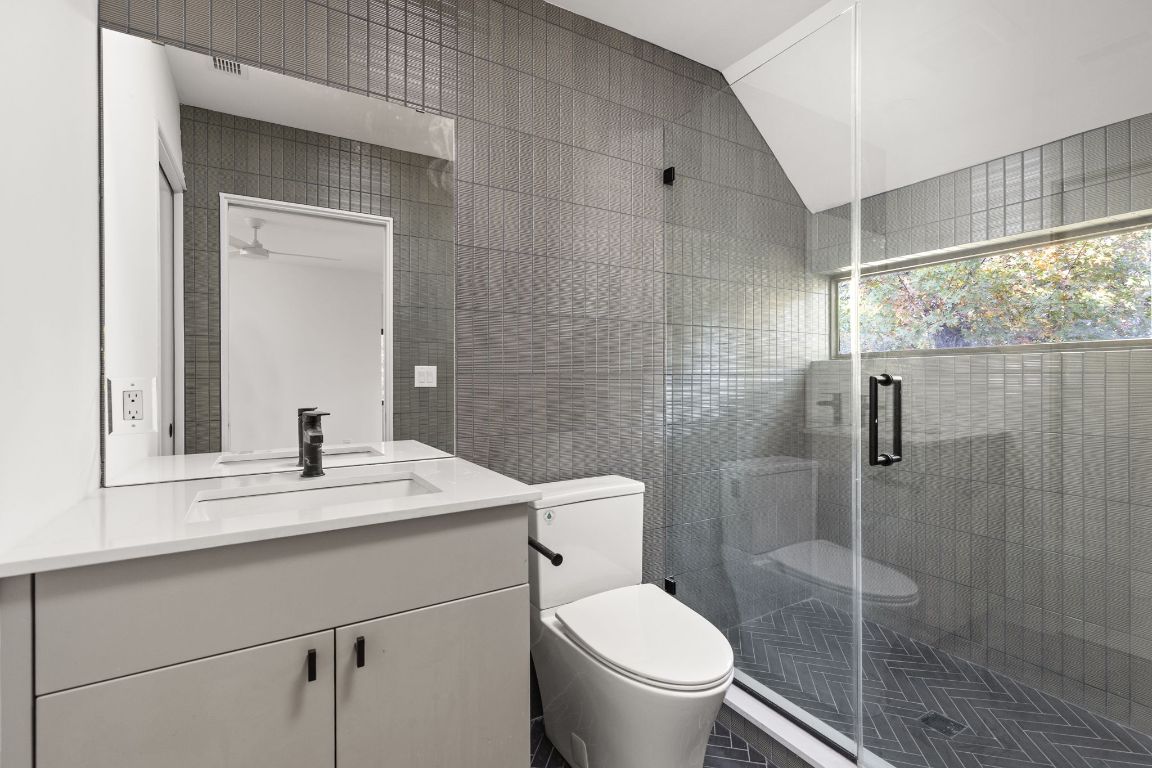 1603 Chelsea Lane, Unit 3 Austin, TX 78704 - Photo 26 of 40 Bathroom with tile walls, vanity, and a stall shower
