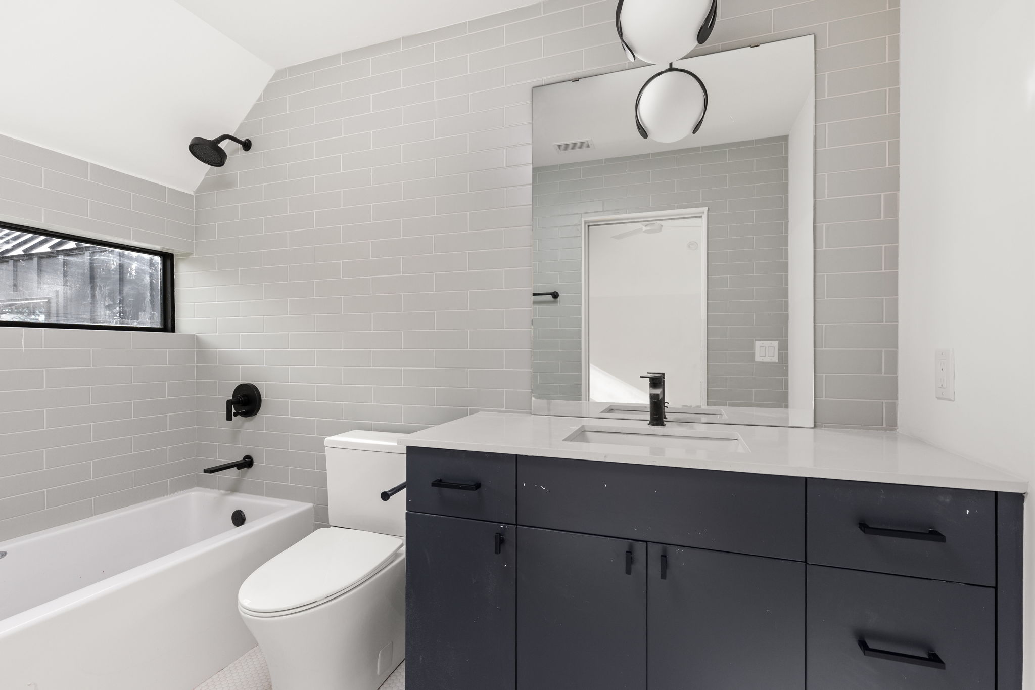 1603 Chelsea Lane, Unit 3 Austin, TX 78704 - Photo 30 of 40 a bathroom with a sink a toilet and a bathtub