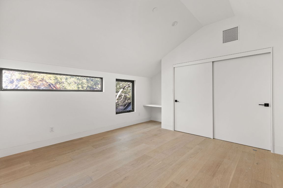 1603 Chelsea Lane, Unit 3 Austin, TX 78704 - Photo 33 of 40 Additional living space featuring light wood-type flooring and vaulted ceiling